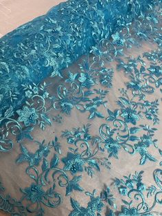 blue lace fabric with flowers on it