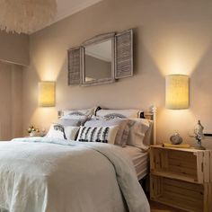 a bed with white sheets and pillows in a bedroom