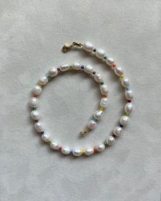 Authentic freshwater pearl Length: 15 inches Pearl: 5x7mm round pearl Glass beads: 3mm multicolor beads Lock: lobster clasp, gold plated stainless steel Multicolor Beaded Necklaces With Pearl Drop, Multicolor Beaded Necklace With Pearl Drop, Multicolor Pearl Drop Necklace, Beaded Rondelle Pearl Necklace, Multicolor Single Strand Pearl Jewelry, Colorful Beaded Baroque Pearl Jewelry For Gifts, Everyday Beaded Pearl White Pearl Necklace, Baroque Pearl Jewelry With Colorful Beads As Gift, Baroque Pearl Jewelry With Colorful Beads For Gift