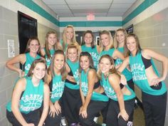 the women's basketball team is posing for a photo in the locker room with their coach