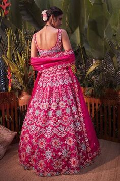 Magenta pink lehenga with mirror work, thread embroidery and foil motifs. Comes with blouse and dupatta. Wedding Dresses With Motifs, Pink Saree With Motifs, Pink Saree Dress With Motifs, Pink Wedding Choli With Motifs, Fitted Wedding Dress With Motifs, Pink Fitted Dress With Motifs, Fitted Pink Anarkali Set With Motifs, Wedding Sets With Pink Motifs, Pink Motif Anarkali Set For Wedding