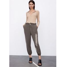 Flowy Baggy Pants High-Waisted Pants With Elastic Waistband. Front Pockets. Elastic Cuffs. Front Zip And Button Closure. Color: Dark Khaki Size: Large Khaki Bottoms With Elastic Waistband For Fall, Khaki Harem Pants With Elastic Waistband For Fall, Fall Khaki Harem Pants With Elastic Waistband, Relaxed Fit Bottoms With Button Cuffs For Loungewear, High-waisted Pants With Button Cuffs For Summer, Khaki High-waisted Pants For Fall, Fall Khaki High-waisted Pants, Chic Baggy Khaki Pants, Chic Khaki Baggy Pants