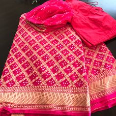 Pink Banaras Bandhni Khaddi Georgette Handloom Saree With A Bell Sleeve Designer Blouse ! Look Stunning And Captivating On This Beautiful Pure Pink Bandhej Banaras Saree. Saree Is Adorned With Gorgeous Gold Zari Jaal Blended With Tie And Die Technique. Ready To Ship Available! 2-3 Days Within Usa! Contact Us For More Details! Khaddi Georgette Blouse Designs, Pink Silk Traditional Wear With Gota Work, Pink Silk Anarkali Set For Transitional Season, Pink Silk Anarkali Set For Navratri, Pink Saree With Gota Work, Transitional Pink Chanderi Sharara, Silk Pink Sharara With Cutdana, Pink Silk Sharara With Cutdana, Pink Blouse Piece With Bandhani Print In Traditional Drape