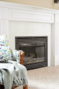 a living room with a fire place in the corner and a blanket on the floor