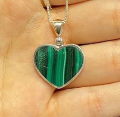 925 Sterling Silver Heart Necklace with Box Chain Malachite is an opaque stone that is a light green to deep green hue. It is found in a unique banded pattern. The bands are white and green and run in parallel streaks. This stone was discovered around 4,000 BC. Malachite translates from Greek to mean mallow, a green leafy herb. Malachite is believed to provide protection to travelers. It has been called the mirror of the soul, because it reflects the inner feelings of a person positive or negati Green Heart-shaped Emerald Necklace, Green Emerald Heart-shaped Necklace, Green Heart Cut Necklace For Gift, Green Sterling Silver Heart Jewelry, Green Sterling Silver Heart-cut Jewelry, Green Heart-shaped Sterling Silver Jewelry, Green Heart Cut Sterling Silver Jewelry, Heart Cut Green Sterling Silver Jewelry, Green Heart-shaped Jewelry Gift