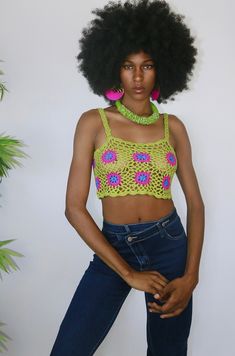 This crochet top is an ultra breezy and edgy style option. She is dyno-mite with a halter swim top or bralette. But for my free spirited sister, you can wear her as is to a festival or beach party. She's a retro green and with pink crochet flowers. She features a corset style back so that you can cater her to your own custom fit! Style Tip: Use as a swim stop cover or style with ribbed denim shorts for a easy casual look Made of Acrylic Scary Crochet, Crochet Outfits, Halter Swim Top, Pink Crochet, Halloween Aesthetic, Sweater Crop, Edgy Style, Crochet Bags, Free Spirited