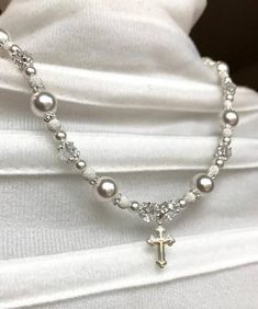 First Communion to Wedding Necklace-- pair this necklace with the matching bracelet: https://www.etsy.com/listing/577480610/first-communion-gift-first-communion-to?ref=shop_home_active_10» » » » WHAT YOU RECEIVE WITH YOUR PURCHASE «  «  « «° Necklace with solid sterling silver beads and spacers° Necklace with solid sterling silver cross charm° Necklace with solid sterling silver chain, clasp, and findings° Necklace with Swarovski crystal pearls° Necklace with Swarovski crystals° Solid sterling s Silver Cross Jewelry For Confirmation, White Sterling Silver Necklace For First Communion, Sterling Silver White Necklace For Baptism, White Sterling Silver Necklace For Baptism, Elegant Personalized Jewelry For Confirmation, Beaded Cross Jewelry For First Communion, Cross-shaped Beaded Jewelry For First Communion, Silver Spiritual Jewelry For First Communion, Elegant Handmade Jewelry For First Communion