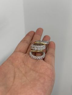 a hand holding three different rings in it