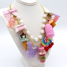 This kawaii statement necklace is called Pink Candy Shop and is a perfect cute charm jewelry gift for any woman in your life including your best friend (or yourself, let's be honest). This piece has been handmade from resin, clay and high quality metal components and features hand painted charms for a quality piece that will be a cute go-to in any charm lovers jewelry collection! Details & Measurements:-Handmade Necklace-High quality glass pearls-Hand-painted charms made from resin & polymer clay-Gumball machine has free floating beads inside! (note it is partially made from glass and fragile)-Choose Gold or Silver Finish -Choose 5, 7 or 9 charms (see list below to find out what charms come on each option)-Charms are chunky and are 1-2" in size (2.5-5cm)-19" (47.5cm) total Necklace Length- Cute Charms Jewelry For Gifts, Playful Charms Jewelry For Birthday, Cute Jewelry For Best Friend Gift, Cute Charms Necklaces For Gifts, Cute Charms Necklaces As Gift, Cute Charms Necklace For Gift, Kawaii Dangle Earrings For Birthday, Pink Fun Style Charm Necklace, Cute Multicolor Dangle Jewelry