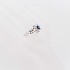 a diamond and blue sapphire ring on a white background