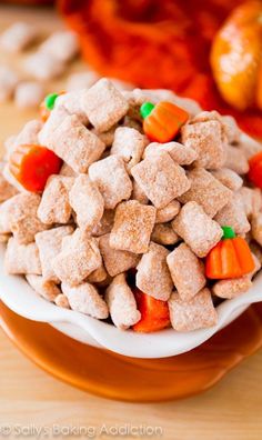 a white bowl filled with puppy chow and carrots