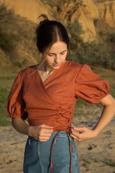 linen blouse, peasant blouse, linen wrap top for women, renaissance tops, linen shirt women, chemise, renaissance shirt A linen top is a stylish and comfortable garment made of light and breathable linen fabric. It has a design where one side of the top wraps around the body to create a flattering V-neck and is secured with laces. This type of top is known for its relaxed and casual chic look, making it a popular choice for casual outings or even semi-formal occasions. The natural texture of the Elegant Spring Dress Shirt, Luxury Cotton Blouse Piece For Designer Wear, Luxury Elegant Summer Peasant Top, Luxury Cotton Silk Blouse Piece For Designer Wear, Cheap Feminine Daywear Shirt, Going To Blouses, Linen Casual Dress Blouse, Luxury Cotton Peasant Top For Women, Feminine Shirt For Daywear