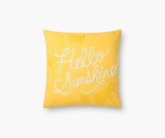 a yellow pillow with the words hello sunshine written in cursive writing on it