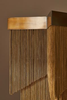 a gold curtain hanging from the side of a wall