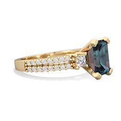 a gold ring with an emerald stone and white diamonds on the side, set in 18k yellow gold