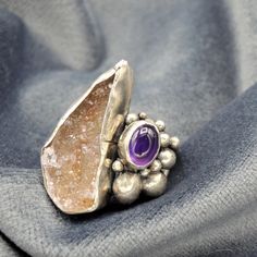 "This is a beautiful rustic and organic ring, an incredible combination of stones. A Druzy of Agate and an Amethyst, enclosed in a special composition. Oxidized and brushed to highlight the surface pattern. Bohemian style inspired by ancient times. This piece is entirely made by myself, soldering sterling silver (925) with traditional Jewelry techniques. Every piece is unique! Ring size: US: 7 1/2 IT: 15 1/2 Top ring size: 1\" x 0,8\" 26 x 20 mm Don't know your ring size? Go here: http://www.onl Unique Natural Stone Ring Jewelry, Unique Natural Stones Ring Jewelry, Unique Natural Stone Ring, Unique Multi-stone Amethyst Ring, Unique Silver Crystal Ring, Fusion Style Natural Stone Ring Jewelry, Healing Crystal Ring With Natural Stones, Unique Amethyst Ring With Stone Setting For Anniversary, Unique Amethyst Ring For Anniversary