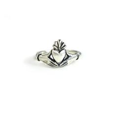 This Claddagh Ring in sterling silver is an original design for my friend Lily's wedding ring. I liked it so much I decided to offer it to others. It is a delicate rendition of the traditional claddagh ring with delicate, feminine hands and wrists. Each wrist wears a single bracelet, opposed to the usual cuff. The hands are fully 3D, and hold the edges of the heart in a realistic way. Oxidized in the crevices to bring out the details, and highly polished throughout. The band measures approximate Classic Sterling Silver Hand Cast Rings, Classic Hand Cast Sterling Silver Rings, Sterling Silver Heart Ring With Polished Finish For Wedding, Sterling Silver Polished Heart Ring For Wedding, Heirloom Sterling Silver Stackable Open Rings, Hand-cast Sterling Silver Promise Jewelry, Heirloom Style Sterling Silver Stackable Rings With Polished Finish, Heirloom Sterling Silver Stackable Rings With Polished Finish, Symbolic Sterling Silver Stackable Promise Rings