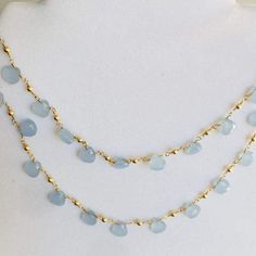 Stunning natural pale blue Chalcedony Necklace! TIt is made with gorgeous natural faceted heart shaped Chalcedony beads. It is beautiful to wear with all neutral colors. The necklace can be worn doubled in a snug fit around the neck for a choker effect. It is a very boho style with a modern twist piece. Wear it alone as long necklace, doubled around the neck for short layered effect or with other gold pieces. We believe in the healing powers and positive energy of precious and semi precious ston Blue Beaded Chalcedony Necklace, Chic Handmade Necklaces, Chic Handmade Beach Necklaces, Blue Chalcedony Bead Necklaces, Blue Chalcedony Gemstone Bead Necklaces, Blue Chalcedony Round Beads Necklace, Elegant Light Blue Necklace With Beaded Chain, Dainty Blue Necklaces For Summer, Elegant Beaded Gemstone Necklace