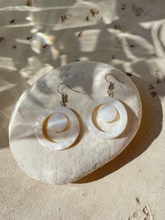 The Nacre2 - Nature Mother of Pearl Earrings are the perfect choice for a simple statement. These earrings are made using natural mother of pearl for understated elegance. Available in four styles, our signature earrings are made to match your favorite Coco De Chom designs. Our Nacre earrings are handmade in Thailand using eco-friendly materials. A unique earring for your vacation or the bohemian bridesmaids.* Measures approx. 2 1/4 inches in length* Earrings are ready to ship* Materials: Mother Bohemian Bridesmaid, Beach Earrings, Mother Of Pearl Earrings, Daily Fashion Inspiration, Mother Pearl, Trendy Accessories, Handcrafted Earrings, Beach Jewelry, Nice Leather