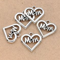 four charms that say mom and three hearts