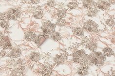 Taupe floral applique and soft pink floral embroidery with silver beads and clear sequins on a pink tulle with scalloped edges. Elegant Embroidered Fabric With Floral Applique For Party, Elegant Silver Sequin Fabric With Floral Embroidery, Elegant Embroidered Spring Lace, Elegant Embroidered Lace For Spring, Elegant Spring Floral Embroidery Lace, Elegant Spring Floral Embroidered Lace, Elegant Tulle With Floral Embroidery Fabric, Elegant Tulle With Floral Embroidery, Elegant Spring Embroidered Fabric With Floral Applique