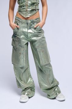 We’re so jelly of how fire you look in The AKIRA Label Green With Envy Metallic Wide Leg Cargo Pant. This glittery metallic-coated cotton denim blend bottom features a high rise waist, functional belt loops, slant side pockets, functional back pockets, and a wide leg silhouette. Complete with a small flap front pocket, dual zippered thigh pockets, and a zip button front closure. This convertible pair includes zip off hems for a cropped look. Style with the coordinating AKIRA Label Green With Envy Lace Up Corset Top for a finished ensemble.  - 75% Cotton 23% Polyester 2% Spandex - Little to No Stretch - Imported  (all measurements are approximate from size small) - 12” Rise - 32.5” Inseam - Model is 5’7”  Product ID: 391674 Black Maria, Lace Up Corset, Green With Envy, Cargo Pant, Corset Top, Cargo Pants, Front Pocket, Casual Pants, Wide Leg