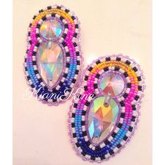 two pairs of colorful beaded earrings on a white surface