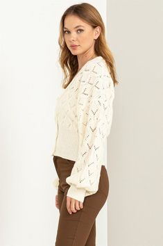 This cardigan is designed to make your days even more delightful. The exquisite pointelle knit detail adorns the entire piece, adding a touch of intricate charm. The button-front bodice exudes timeless elegance and is framed by a classic V-neckline that flatters your neckline. The ribbed cuffs and hem provide a finishing touch, enhancing the overall texture and fit of the cardigan. Model is wearing a smallModel SpecsHeight: 5'9"Bust: 34"Waist: 24"Hips: 35" Fabric Contents: 79% Polyester 21% Acry Chic Button-up Cardigan In Pointelle Knit, Chic Button-up Pointelle Knit Cardigan, Chic Button-up Cardigan With Pointelle Knit, Classic Open Knit Sweater For Spring, Elegant Pointelle Knit Cardigan For Spring, Elegant Open Knit Long Sleeve Cardigan, Elegant Long Sleeve Open Knit Cardigan, Chic Cream Pointelle Knit Cardigan, Classic Spring Pointelle Knit Cardigan