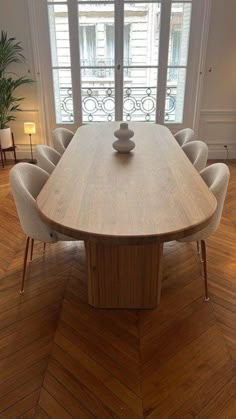 a large wooden table with six chairs around it