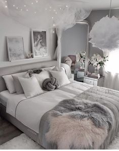 an instagram photo of a bedroom with white and gray decor on the walls, bedding