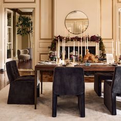 a dining room table with chairs and candles