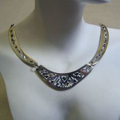 This handsome multi piece necklace features the incredible work of the Mexican metalsmiths. It is made of alpaca metal which looks like silver and wears like iron. The metal is an alloy with zinc, copper and sometimes nickel. The inlay work is lustrous pieces of abalone shell which are the color of a stormy sky but radiate colors of blue, green and pink. The background is white enamel in the metal which makes this a perfect spring or summer necklace. The necklace measures 17 inches long and each Unique Silver Etched Necklaces, Artisan Silver Etched Necklace, Artisan Silver Engraved Necklaces, Silver Hand Forged Metal Necklace, Hand Forged Silver Metal Necklace, Unique Engraved Metal Jewelry, Artisan Metal Jewelry With Etched Details, Unique Etched Metal Jewelry, Artisan Etched Metal Jewelry