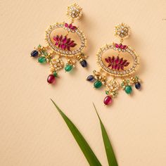 Description : Discover timeless charm with our chandbali earring showcasing a central Pink Lotus motif, elegantly framed by a delicate design. Hanging beneath are colorful beads, adding a playful and vibrant touch to this graceful piece. Pair it effortlessly with both traditional and contemporary outfits for a touch of elegance. Product Information Materials used: 925 Silver with 1.0-microns Antique Gold Plating Stones: Semi precious stones Length: 8cm Findings: Hook Lotus Motif, Lotus Earrings, Chandbali Earrings, Pink Lotus, Delicate Design, Contemporary Outfits, Semi Precious Stones, Gold Plating, Antique Gold