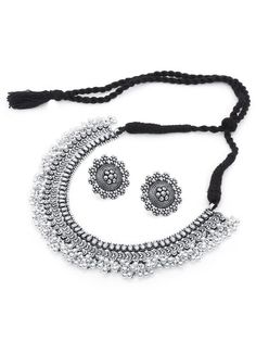 This jewellery set consists of a necklace, a pair of earrings, a finger ring and a nose pin Oxidised silver-plated choker necklace, has intricate textured detailing and bead droplets, secured with a drawstring closure A pair of matching stud earrings, secured with post-and-back closure Oxidised silver-plated adjustable finger ring, has a floral-shaped design motif Oxidised silver-plated nose pin with clip-on closure Size & Fit Necklace length: 42 cm Necklace width: 3 cm Earring length: 2.8 cm each Nose pin length: 1.7 cm Ring dimension: Adjustable Material & Care Material: German silver Plating: Oxidized silver-plated Care Instructions: Wipe your jewellery with a soft cloth after every use Always store your jewellery in a flat box to avoid accidental scratches Keep sprays and perfumes away Alloy Choker Jewelry For Wedding, Alloy Choker For Wedding, Silver Beads Choker Jewelry Gift, Alloy Wedding Choker Jewelry, Antique Silver Jewelry With Silver Beads For Festival, Festive Metal Jewelry With Intricate Design, Silver Metal Temple Jewelry Choker, Ornate Jewelry For Festivals And Jewelry Making, Ornate Jewelry For Jewelry Making And Festivals