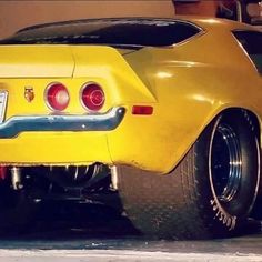 the rear end of a yellow sports car