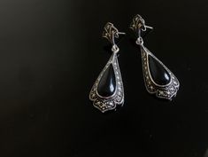 A lovely pair of Art Deco silver earrings, c1920.   Each antique earring has been adorned with ample sparky marcasites on a bed of solid silver, centred with an oval onyx. Beautifully sparkly Art Deco earrings.  So very elegant. Would make a lovely gift for her or bridal earrings. All stones intact. In lovely vintage condition.  Measurements: approximately 4cm Gift wrap: Free gift wrap with this item  Please see below link for gift wrapping service; https://www.etsy.com/uk/listing/822273297/ Mat Art Deco Hallmarked Drop Earrings, Victorian Style Silver Earrings For Pierced Ears, Art Deco Pierced Earrings For Formal Occasions, Art Deco Style Pierced Earrings For Formal Occasions, Ornate Handmade Evening Earrings, Antique Handmade Evening Earrings, Hallmarked Teardrop Earrings For Evening, Antique Handmade Earrings For Evening, Handmade Ornate Earrings For Evening