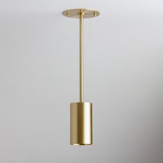 a gold colored light fixture hanging from a ceiling in a room with white walls and flooring