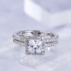 a princess cut diamond surrounded by pave set diamonds