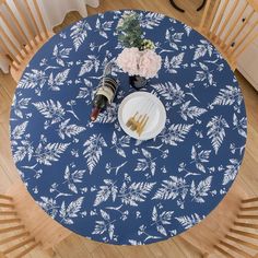 a blue table cloth with white flowers on it