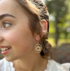 "This listing is for one pair of small white Needle Chrysanthemum resin earrings in small oval shaped frames. These white Needle Chrysanthemum earrings are light weight, hand poured, carefully crafted and uniquely designed! Created with real dried flowers, these earrings are a perfect gift for a friend, girlfriend, wife, fiancé or even for yourself!   -All of our earrings use NICKEL FREE AND LEAD FREE HYPOALLERGENIC HOOKS.   Every earring is hand crafted and so each are unique! CHECK OUT OTHER BEAUTIFUL OPTIONS FROM OUR CHRYSANTHEMUM COLLECTION -Tear dropped shaped Needle Chrysanthemum Earrings: https://www.etsy.com/listing/1485295330 -Heart shaped Needle Chrysanthemum Earrings: https://www.etsy.com/listing/1485270786 -Circle Shaped Needle Chrysanthemum Earrings: https://www.etsy.com/listi Delicate Hypoallergenic Flower Earrings For Everyday Wear, Delicate White Teardrop Flower Earrings, Delicate Hypoallergenic Dangle Flower Earrings, Delicate Teardrop Flower Earrings For Pierced Ears, Delicate Teardrop Flower Earrings, White Pressed Flower Earrings For Wedding, White Flower Earrings With Pressed Flowers For Wedding, Handmade Clear Earrings For Everyday, Elegant White Earrings With Pressed Flowers