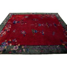 a red rug with floral designs on it