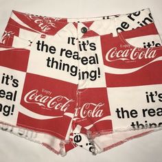 a pair of red and white shorts with the words it's real thing printed on them