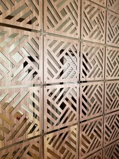 an intricate wooden wall with geometric designs on it