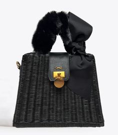 MME.Mink Winter Monaco Petite Fur Bag in Noir Our most popular wicker bag is back for Fall/Winter 2022 dressed up! Our Monaco Bag is this season's fanfare piece, inspired by Grace Kelly's glamorous lifestyle on the Riviera. This bag's clam-shell opening securely closes with a snap feature and the simple interior is a lightweight organic twill with a slip pocket. SIZE: 10"W x 11"H x 5"D Material: Organic Woven Wicker Tote with twill lined interior. Chic Top Handle Straw Bag, Designer Black Straw Bag With Top Handle, Luxury Straw Bag With Top Handle And Detachable Strap, Elegant Straw Bag With Detachable Strap, Elegant Straw Tote Bag With Detachable Strap, Chic Straw Bag With Detachable Handle, Chic Top Handle Straw Bag With Detachable Handle, Chic Straw Top Handle Bag With Detachable Handle, Elegant Straw Shoulder Bag With Detachable Handle