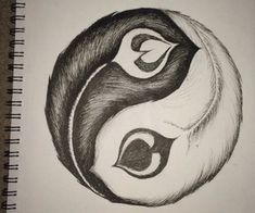 a black and white drawing of two faces in a yin - yang style on paper