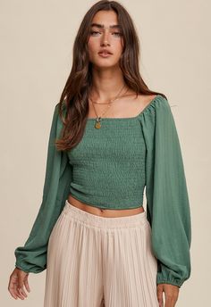 This Jade Smocked Blouse is an ideal transition piece, featuring a smocked bodice and peasant sleeve. Its bohemian style makes it perfect for casual days and special occasions, combining comfort and fashion. With its flattering silhouette, you'll feel confident and stylish all day. Available in Small, Medium and Large Runs true with an easy, stretchy fit Fall Peasant Top With Smocked Bodice, Flowy Long Sleeve Blouse With Smocked Back, Chic Green Blouse With Smocked Bodice, Long Sleeve Peasant Top With Smocked Back, Flowy Blouse Outfit, Square Neck Puff Sleeve Top, Fitted Smocked Top With Gathered Sleeves, Cropped, Peasant Sleeve, Smock Blouse