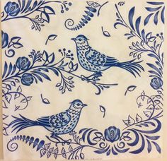 a blue and white plate with two birds on it