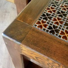 a close up of a wooden bench with hearts on it's back and sides