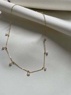 This necklace is handcrafted in brass with an elegant touch with the precious pearl charm attached. It's so minimalist but sophisticated, elegant but classy, simple but unique! It can match almost everything in your closet! //Materials// ✔️ pearl  ✔️ Chain, brass //Necklace Length// 18"  //Special Notes// **Feel free to ask me anything if you have concerns ! Fresh water pearl Adjustable Gold Charm Necklace With Pearl Chain, Adjustable Gold Charm Necklace With Pearl Pendant, Gold Charm Necklace With Pearl Chain And Adjustable Fit, Gold Pearl Necklace With Clavicle Chain Dangle, Minimalist 14k Gold Pearl Pendant Necklace, Minimalist 14k Gold Pearl Necklace, Minimalist Pearl Charm Chain Necklace, Gold Pearl Charm Necklace With Pearl Drop, Gold Pearl Drop Charm Necklace