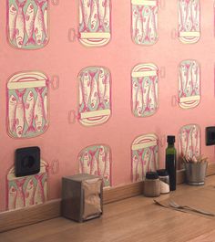 there is a pink wall with fish on it and two speakers in front of the wall